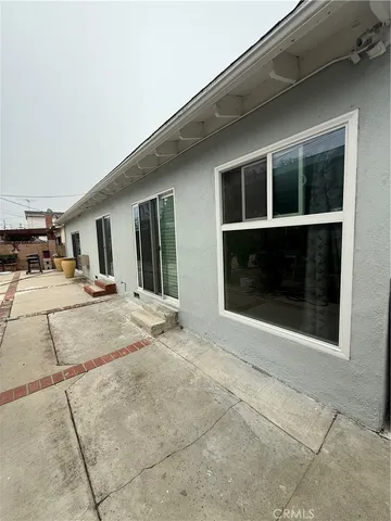 a view of a house with glass windows and a street