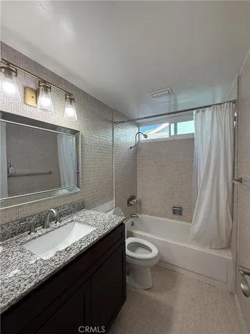 an empty room with floor to ceiling window and closet