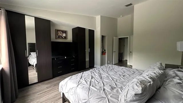 a bedroom with a bed and a mirror