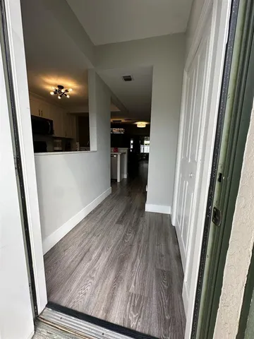 a view of a hallway view with wooden floor and staircase
