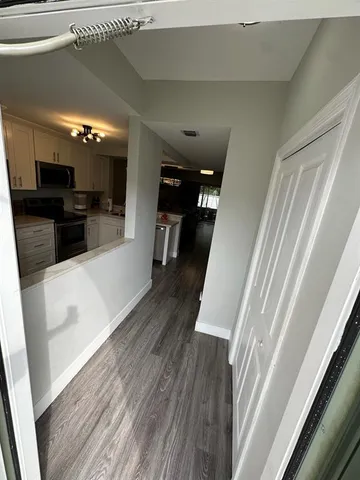 a view of a living room with furniture and wooden floor