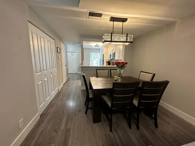 a view of a dining room with furniture window and wooden floor