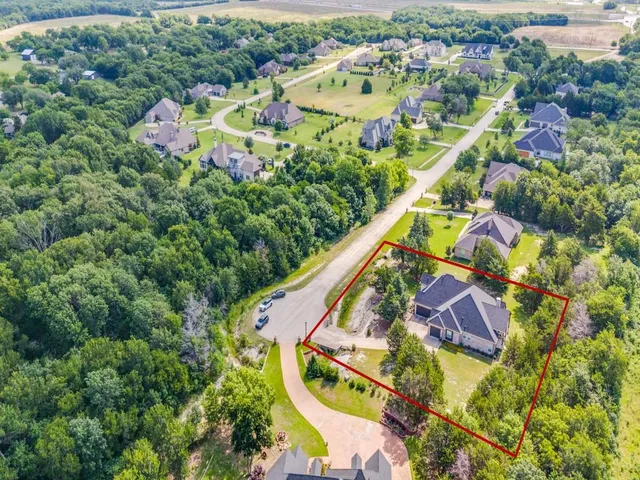 an aerial view of residential house with outdoor space and swimming pool