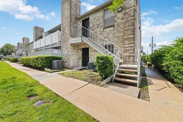 a backyard of a house with plants and a garden