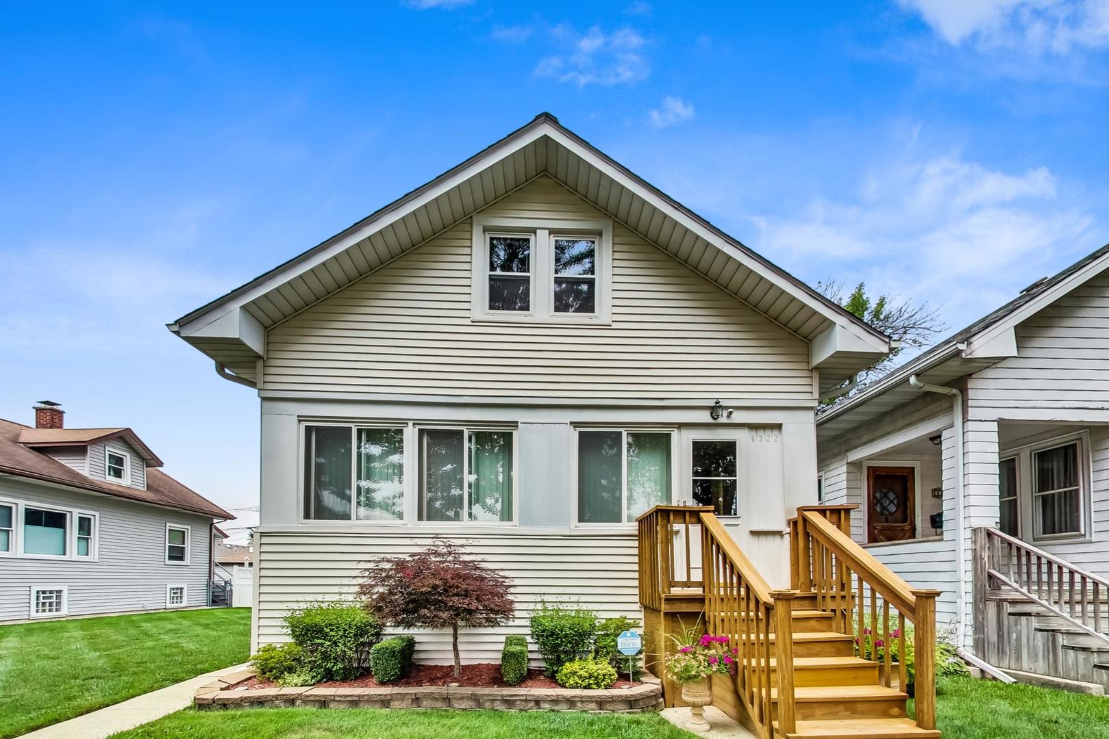 6322 West Huntington Street Chicago, IL 60646 - Photo 1 of 51 a front view of a house with garden
