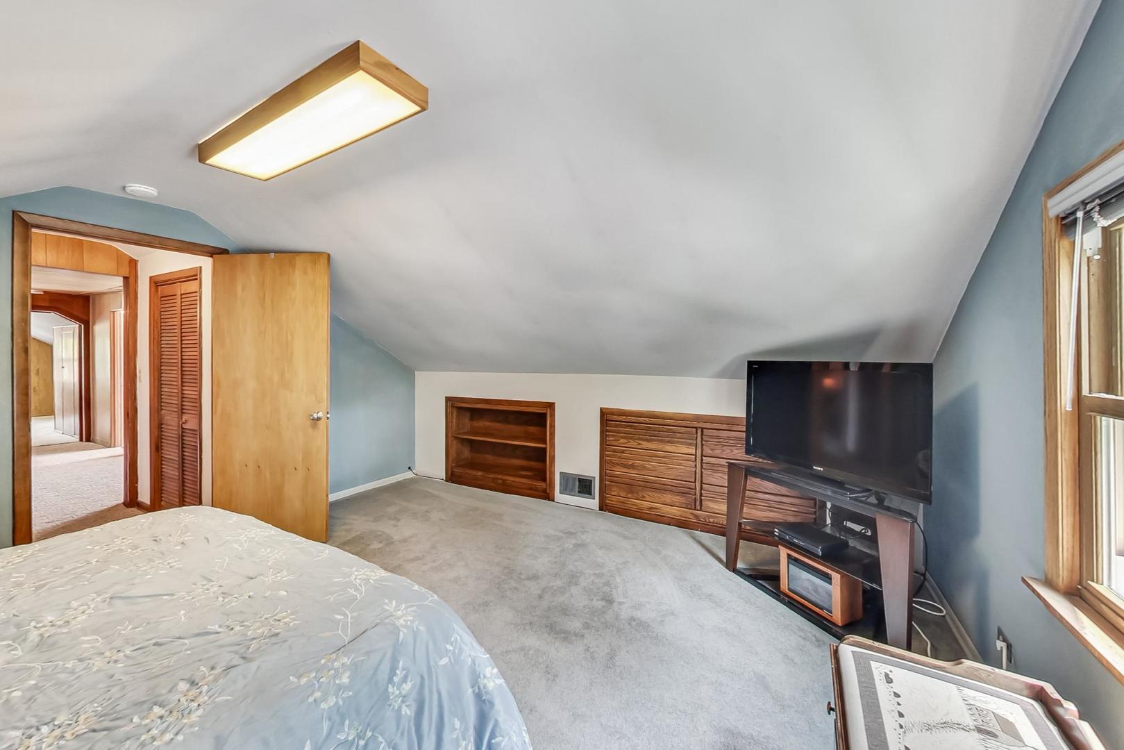 6322 West Huntington Street Chicago, IL 60646 - Photo 24 of 51 a bedroom with a bed and a flat screen tv
