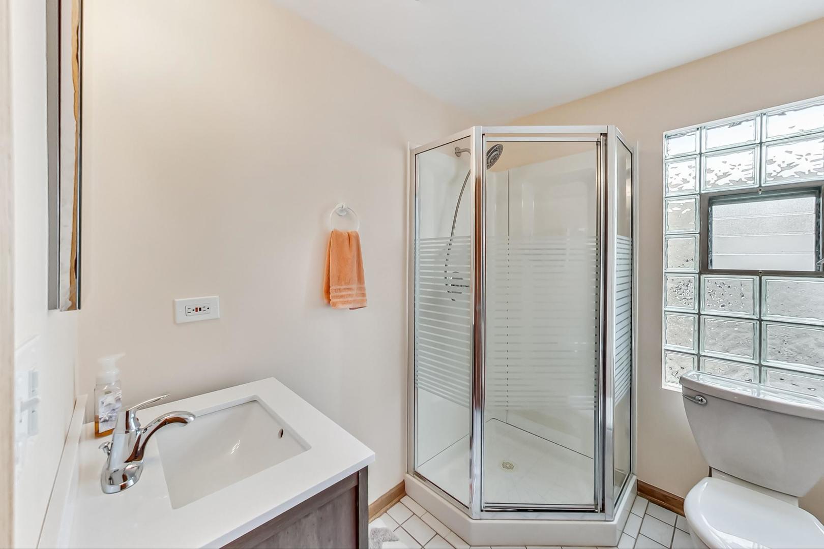 6322 West Huntington Street Chicago, IL 60646 - Photo 27 of 51 a bathroom with a sink toilet and shower