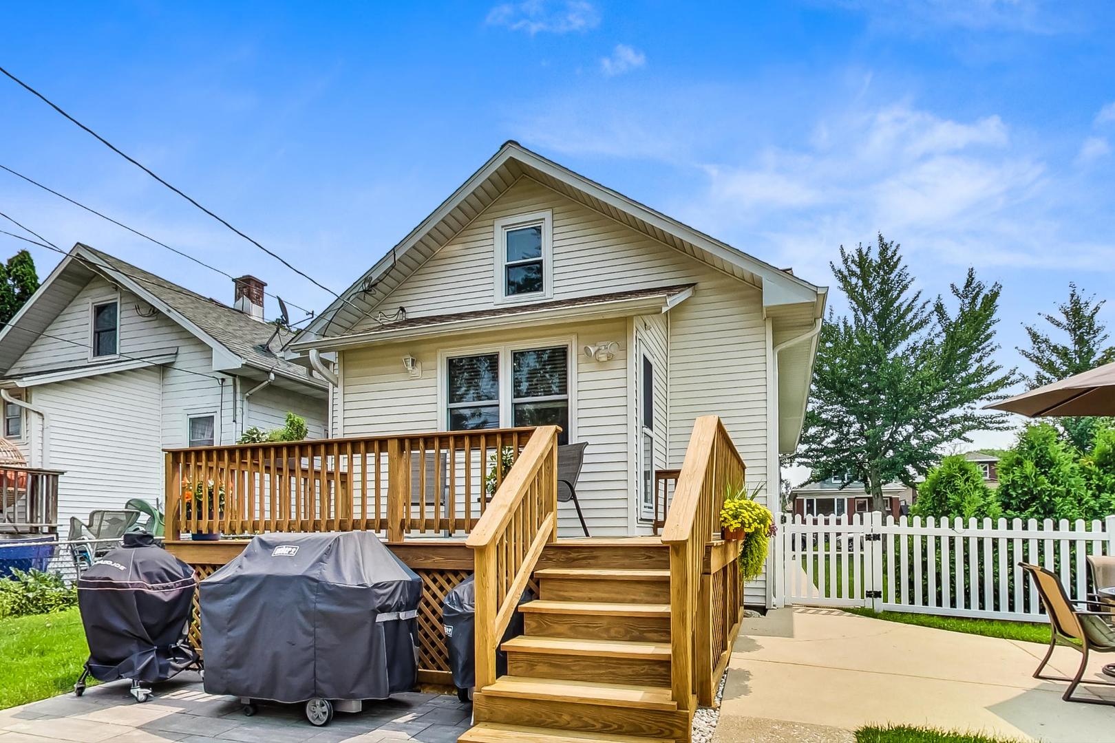 6322 West Huntington Street Chicago, IL 60646 - Photo 36 of 51 a view of a house with wooden deck and furniture