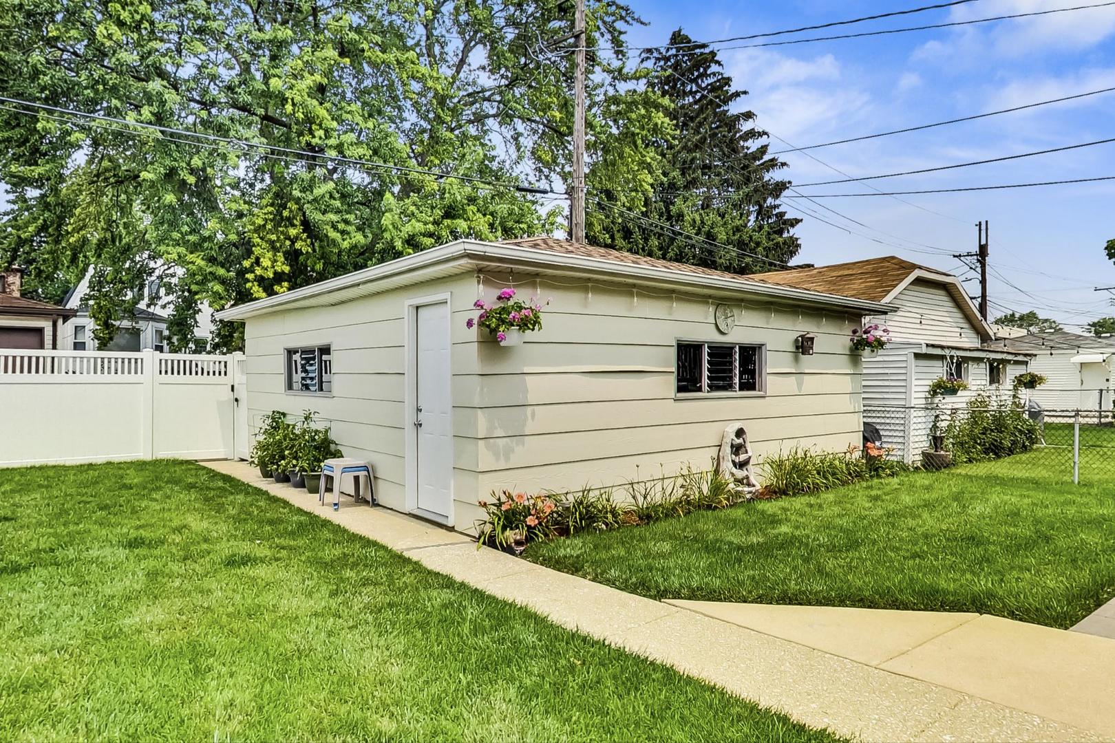 6322 West Huntington Street Chicago, IL 60646 - Photo 43 of 51 a front view of a house with a yard