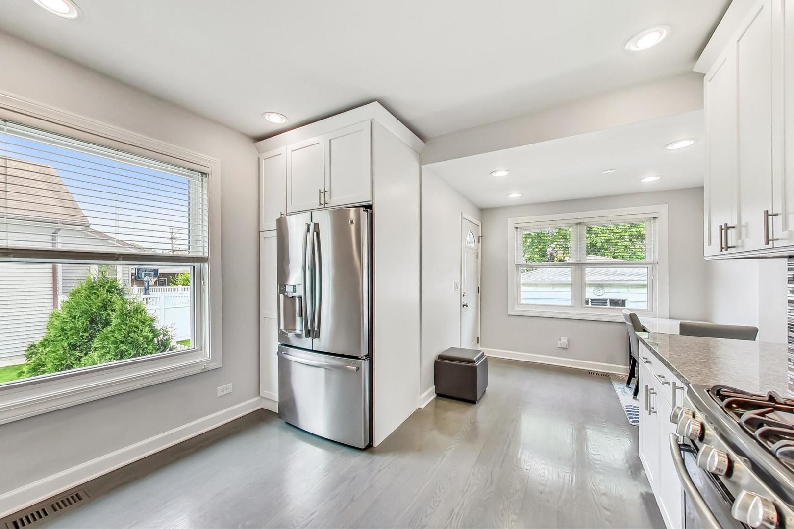 6322 West Huntington Street Chicago, IL 60646 - Photo 6 of 51 a kitchen with stainless steel appliances a refrigerator and a stove top oven