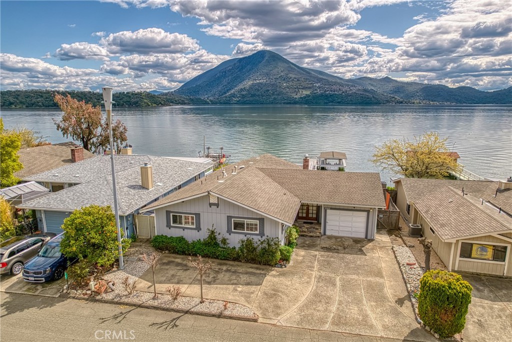 a front view of a house with a yard and potted plants