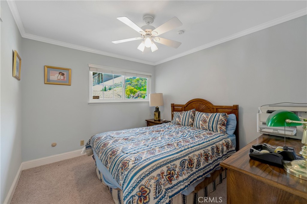 7753 Cora Drive Lucerne, CA 95458 - Photo 17 of 36 a bedroom with a bed and a chandelier