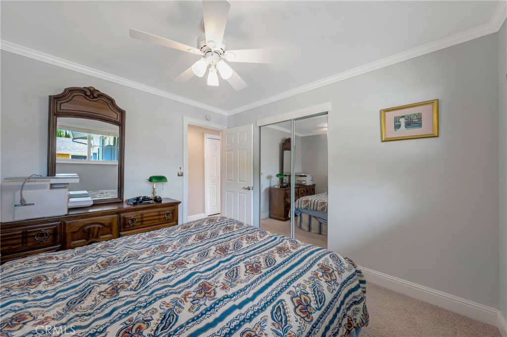 7753 Cora Drive Lucerne, CA 95458 - Photo 18 of 36 a bedroom with a bed and a chandelier