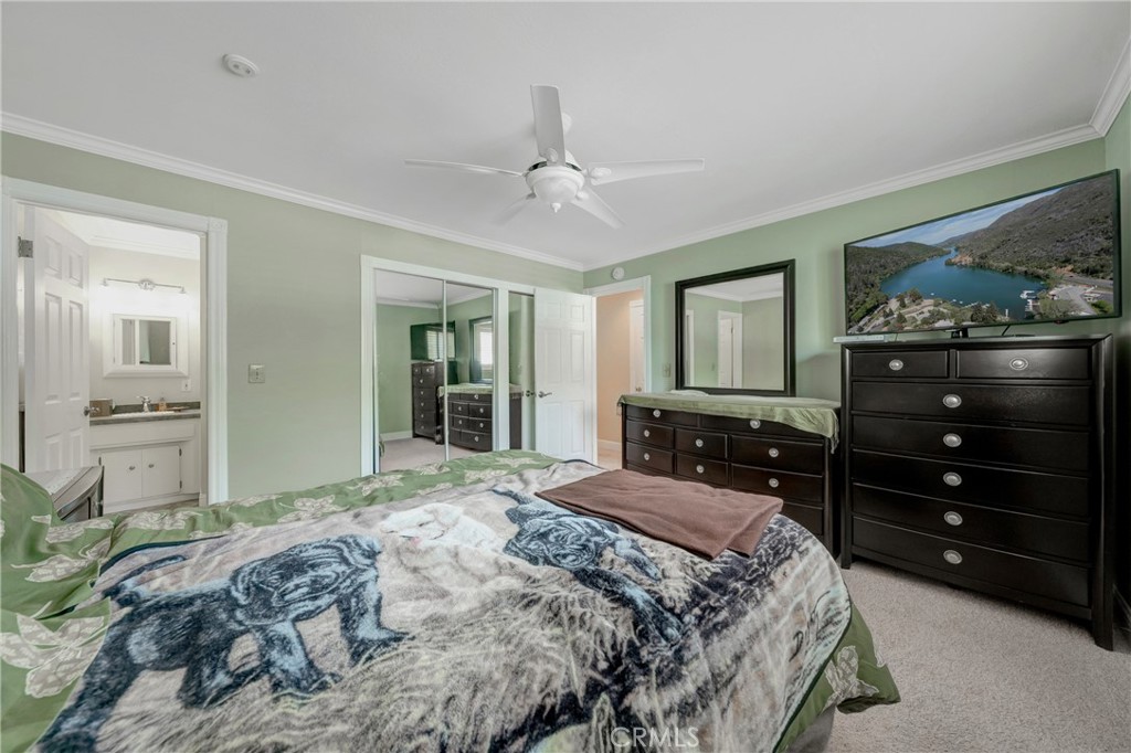 7753 Cora Drive Lucerne, CA 95458 - Photo 21 of 36 a bedroom with a bed and a dresser