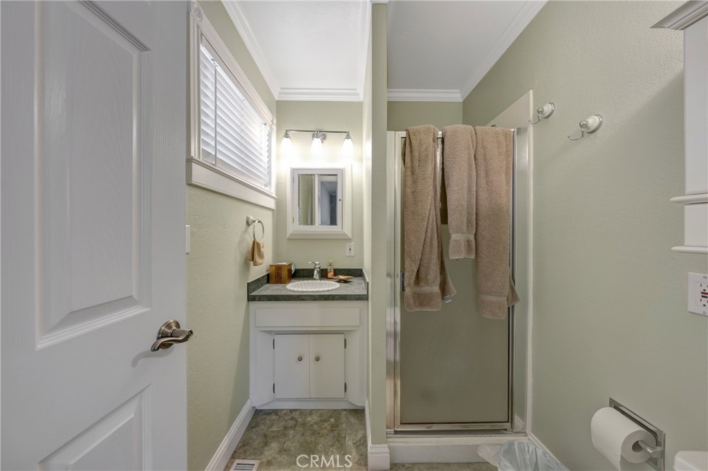 7753 Cora Drive Lucerne, CA 95458 - Photo 22 of 36 a bathroom with a granite countertop sink and shower