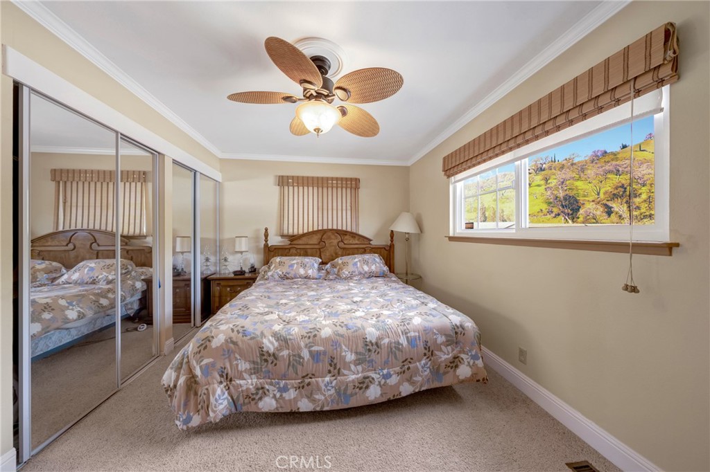 7753 Cora Drive Lucerne, CA 95458 - Photo 23 of 36 a bedroom with a bed and window