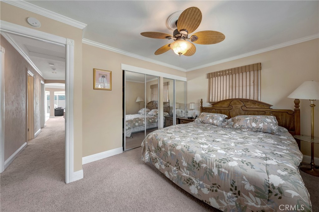7753 Cora Drive Lucerne, CA 95458 - Photo 24 of 36 a bedroom with a bed and a chandelier