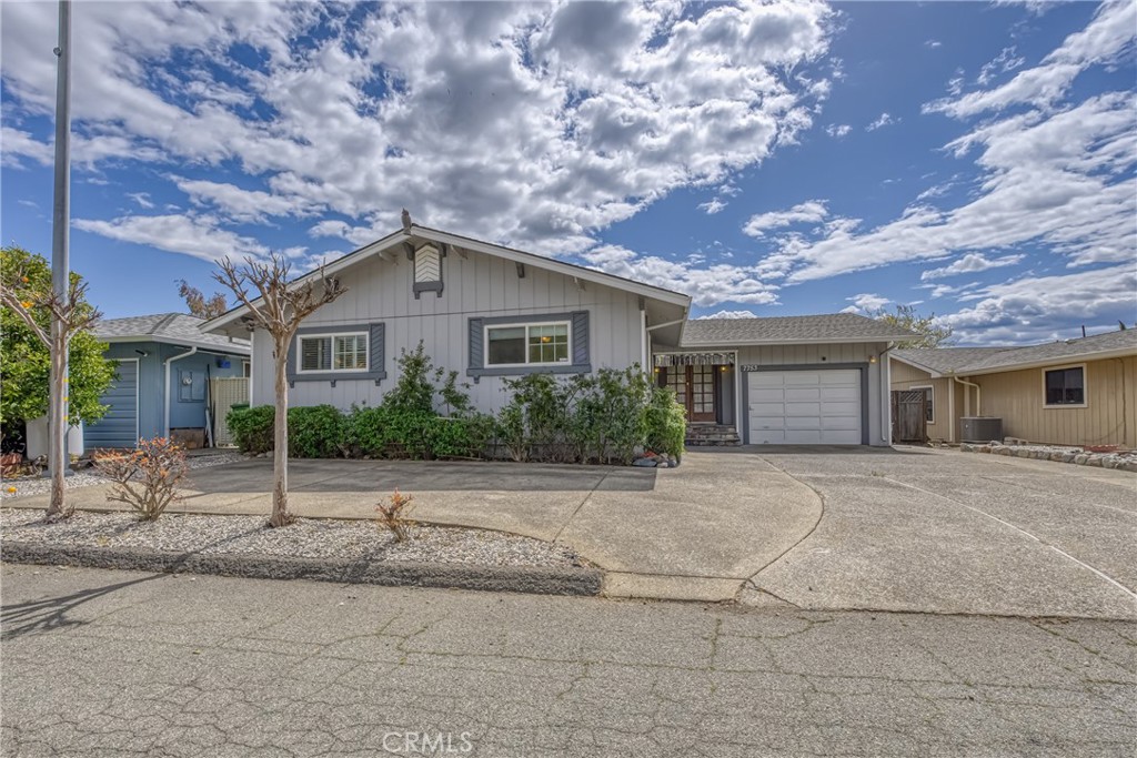 7753 Cora Drive Lucerne, CA 95458 - Photo 5 of 36 a front view of a house with a yard and garage