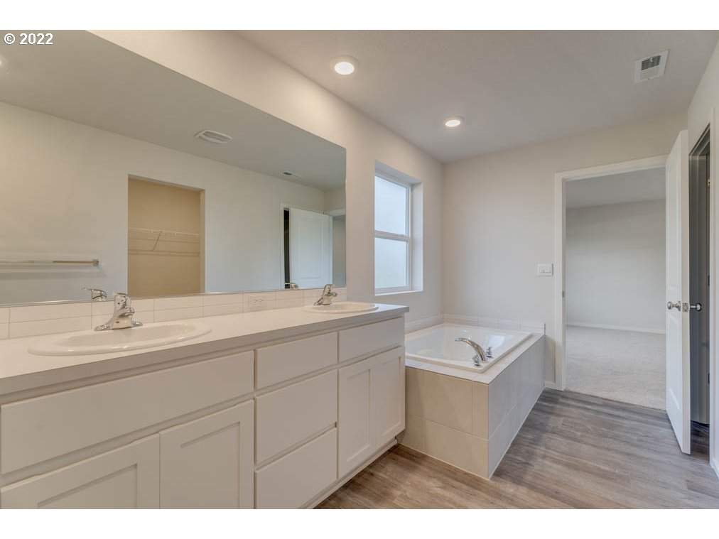 2894 V Street Springfield, OR 97477 - Photo 17 of 23 a bathroom with a sink a tub and a mirror