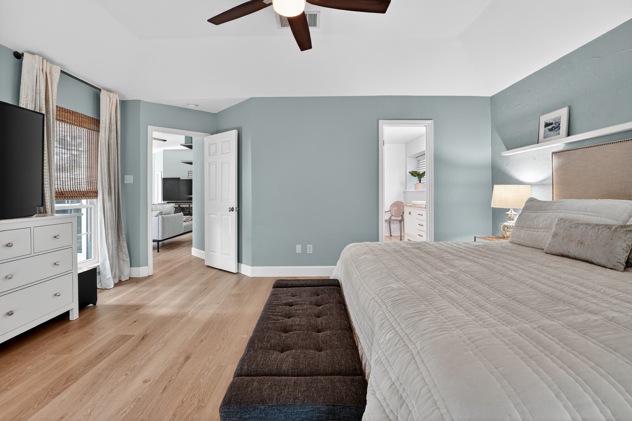 1811 Old Mill Road Cedar Park, TX 78613 - Photo 22 of 39 Hardwood floors and vaulted ceilings create a spacious and elegant atmosphere in this primary bedroom.