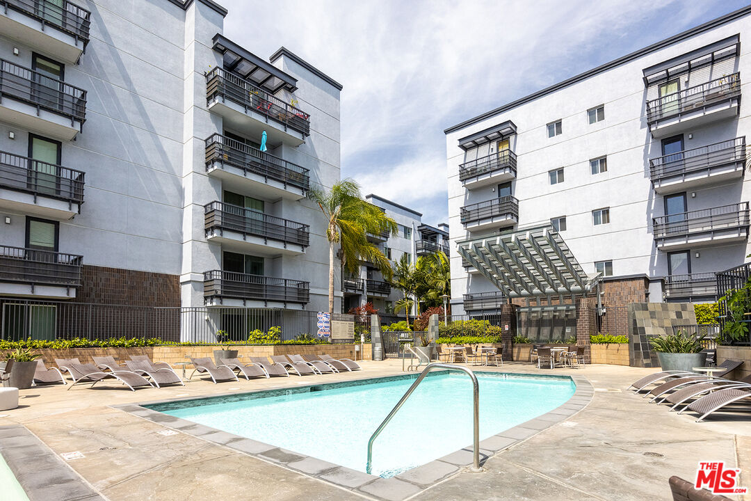 a view of building with yard and swimming pool