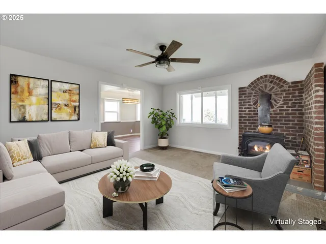 a living room with furniture a chandelier and a window