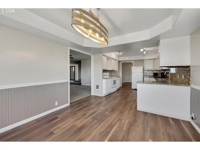 a view interior of kitchen and hall with wooden floor