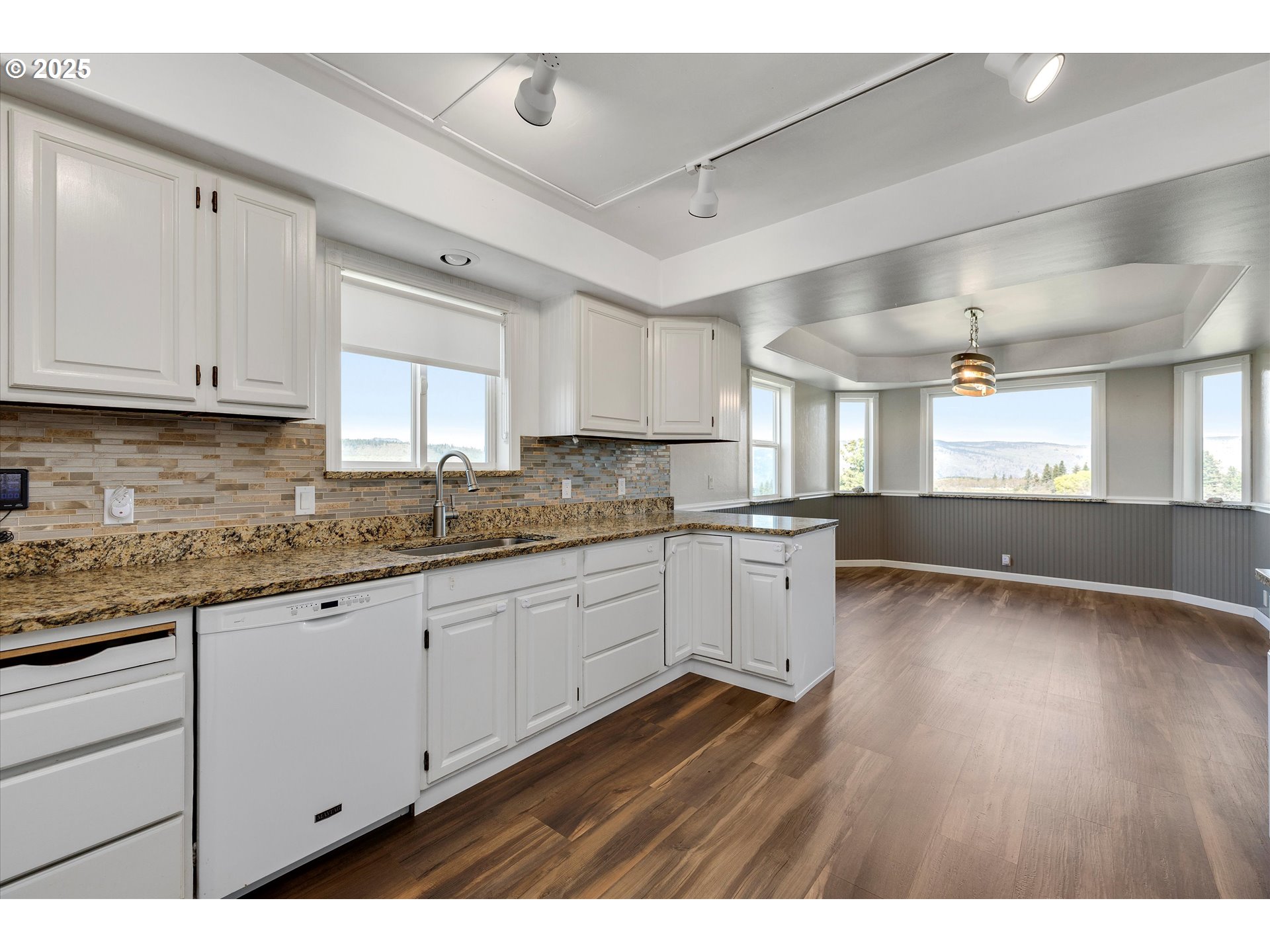 1805 Carroll Road Mosier, OR 97040 - Photo 16 of 45 a kitchen with granite countertop a sink cabinets and wooden floor