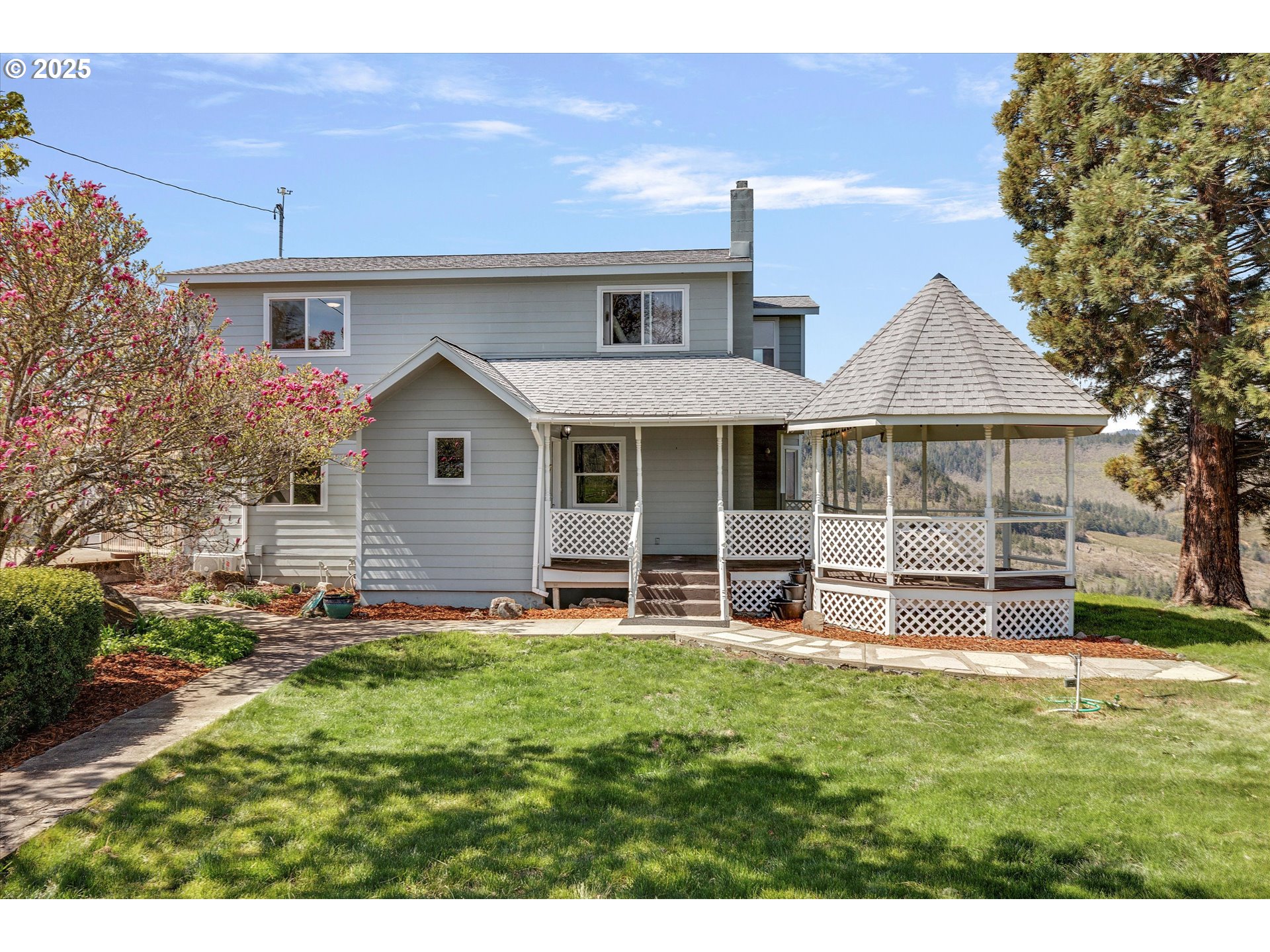1805 Carroll Road Mosier, OR 97040 - Photo 9 of 45 a front view of house with a garden and patio
