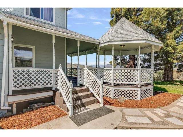 a view of a chair and tables back yard of the house