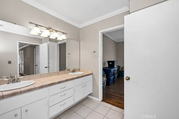 a bathroom with a double vanity sink and a mirror