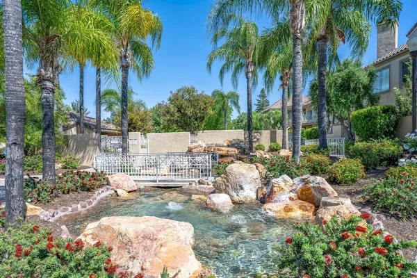 a view of a backyard with swimming pool