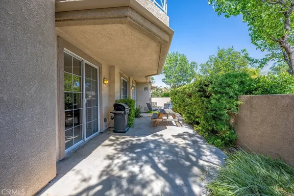 a view of yard from deck with patio