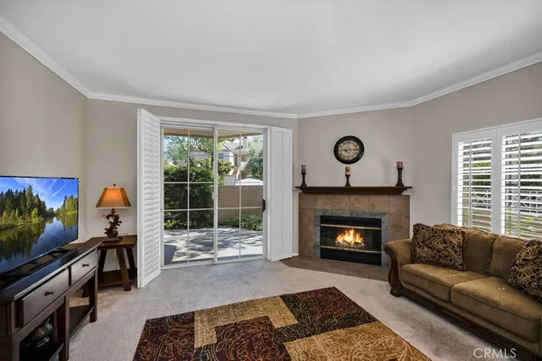 a living room with furniture a window and a chandelier
