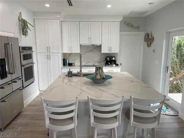 a kitchen with a table chairs and refrigerator