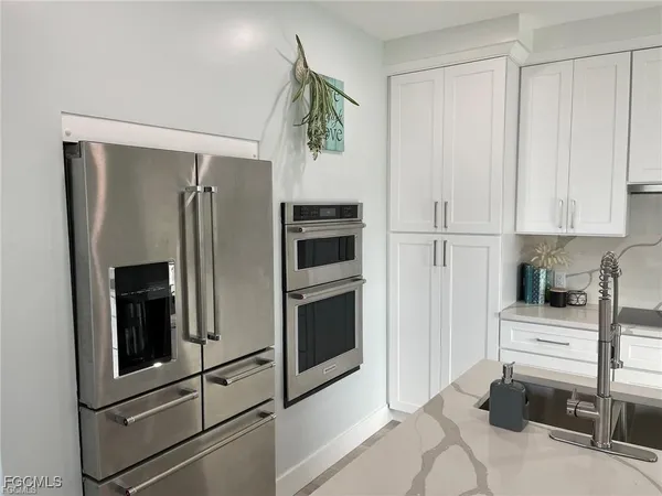a view of kitchen and refrigerator