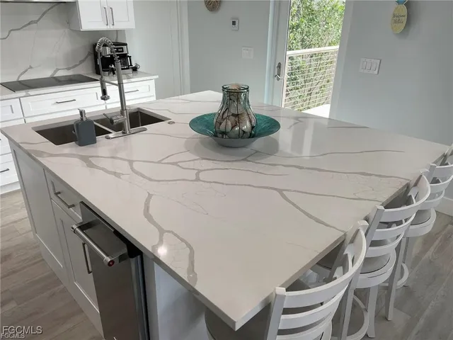 a kitchen with a sink and a potted plant