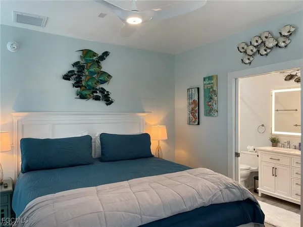 a bedroom with a bed and a potted plant