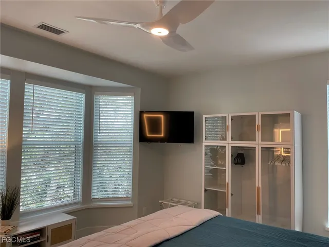 a bedroom with a bed and a flat screen tv