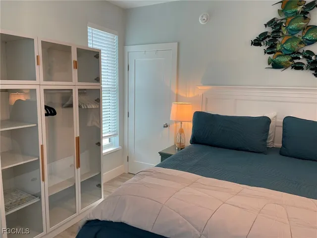 a bedroom with a bed and a potted plant