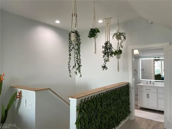 a view of a hallway and chandelier fan