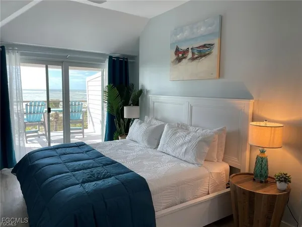 a bedroom with a bed and a lamp