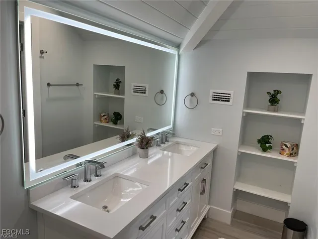 a bathroom with a sink double vanity and a mirror