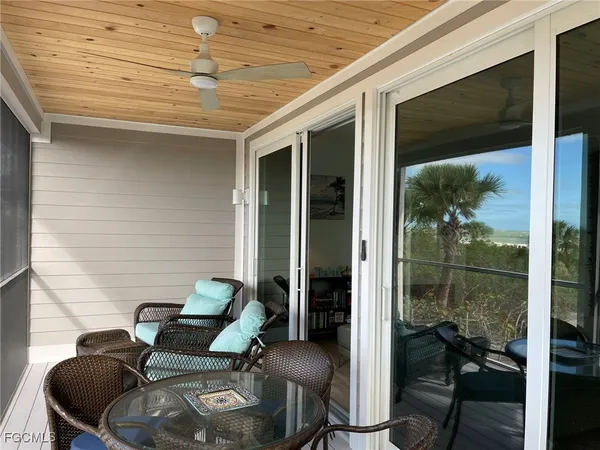 a balcony with furniture and wooden floor