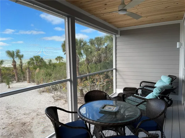 a view of a balcony dining table and chairs
