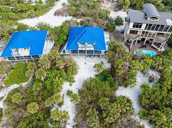 an aerial view of multiple houses with yard