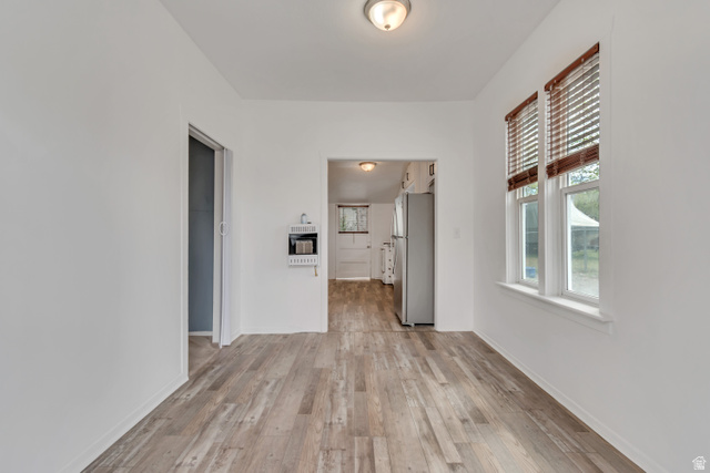 8831 South 400 East Sandy, UT 84070 - Photo 9 of 26 Empty room featuring light wood-style flooring and heating unit