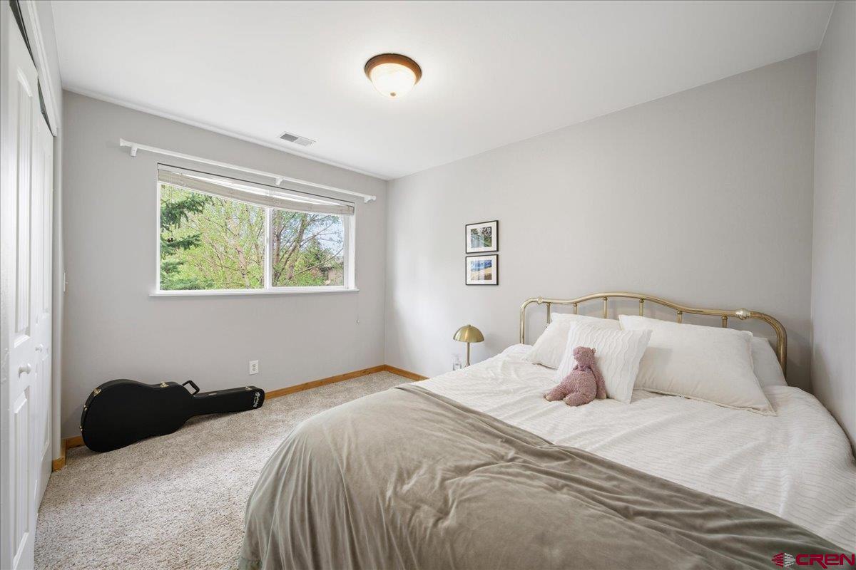 520 Redcliff Circle, Unit G203 Ridgway, CO 81432 - Photo 12 of 25 a bedroom with a bed and a window