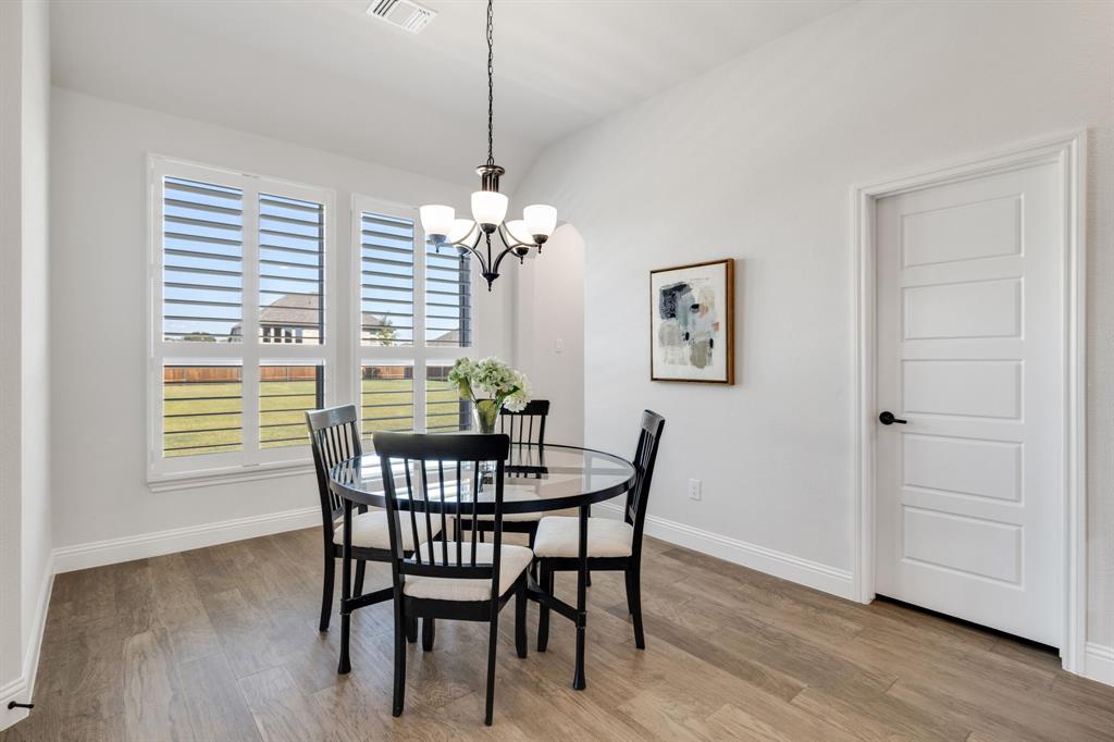 707 Soprano Drive Forney, TX 75126 - Photo 16 of 37 a view of a dining room with furniture window and wooden floor