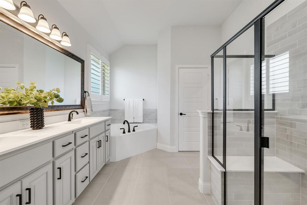 707 Soprano Drive Forney, TX 75126 - Photo 19 of 37 a bathroom with a double vanity sink mirror and shower
